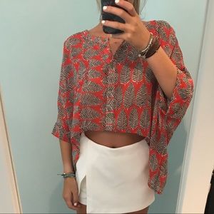 orange blouse with leaves on it